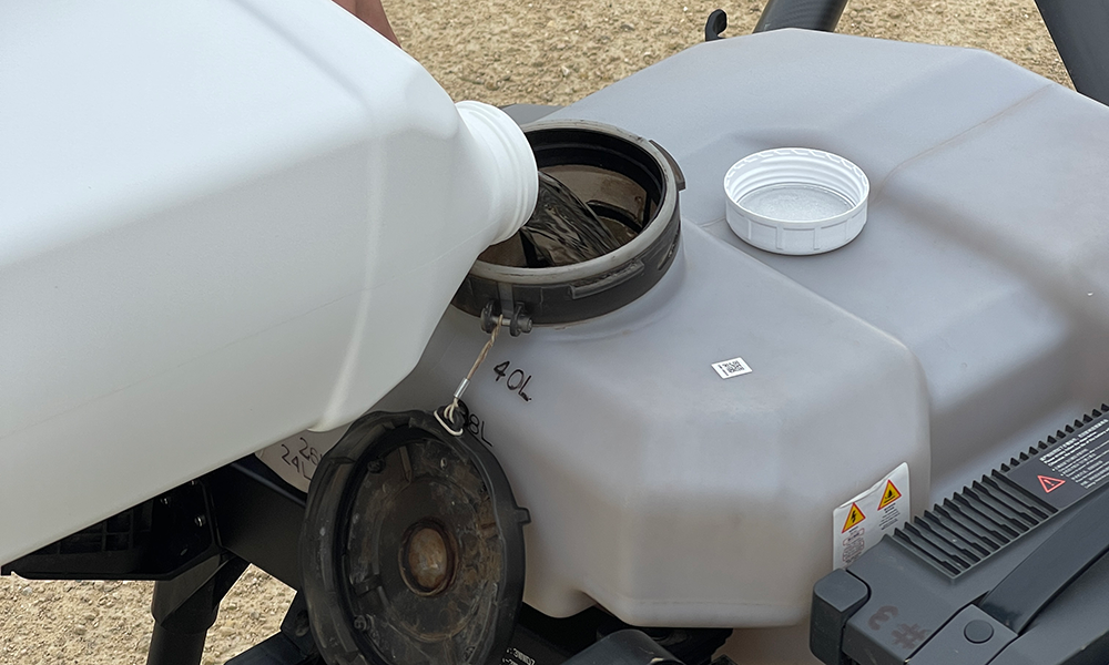 applicator filling drone spray tank with pesticide and adjuvant tank mix